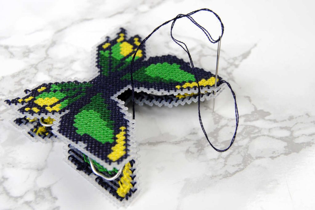 Sewing together the two cross stitch pieces with wire in between them.