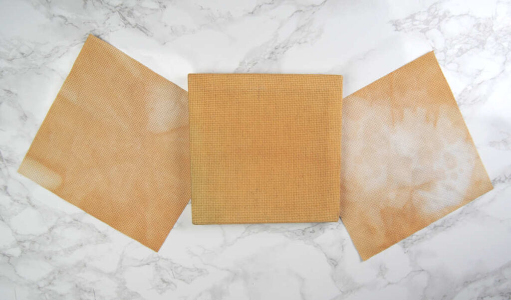 Three pieces of 14 count aida dyed / stained with tea.