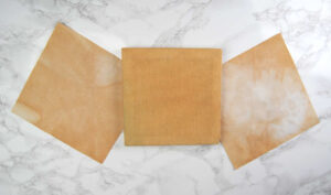 Three pieces of 14 count aida dyed / stained with tea.