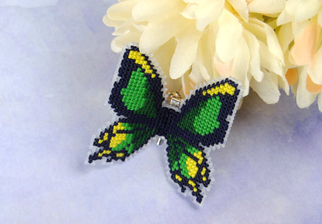 The Thunderwing butterfly from The Legend of Zelda, cross stitched as a 3d poseable pin.