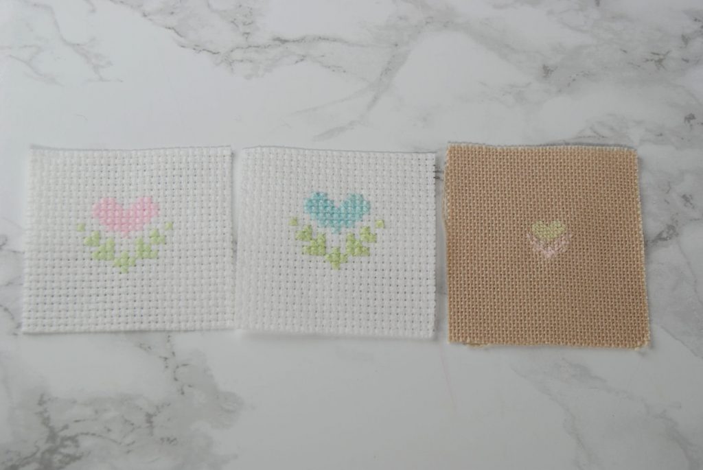 Three similar designs stitched on different fabric counts with different strand counts to show case coverage.