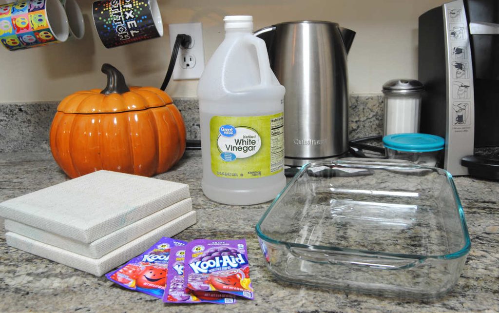 Materials for fabric dyeing: Vinegar, Kool-Aid, Fabric, and a container to dye in.