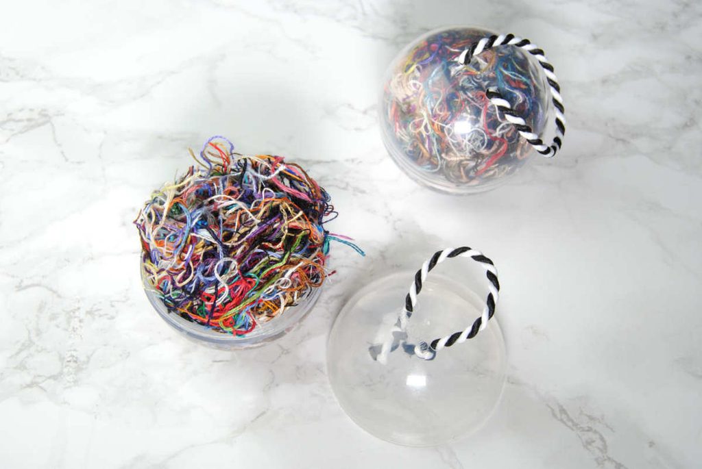 Small plastic orbs full of ORTs to be used as Christmas ornaments.