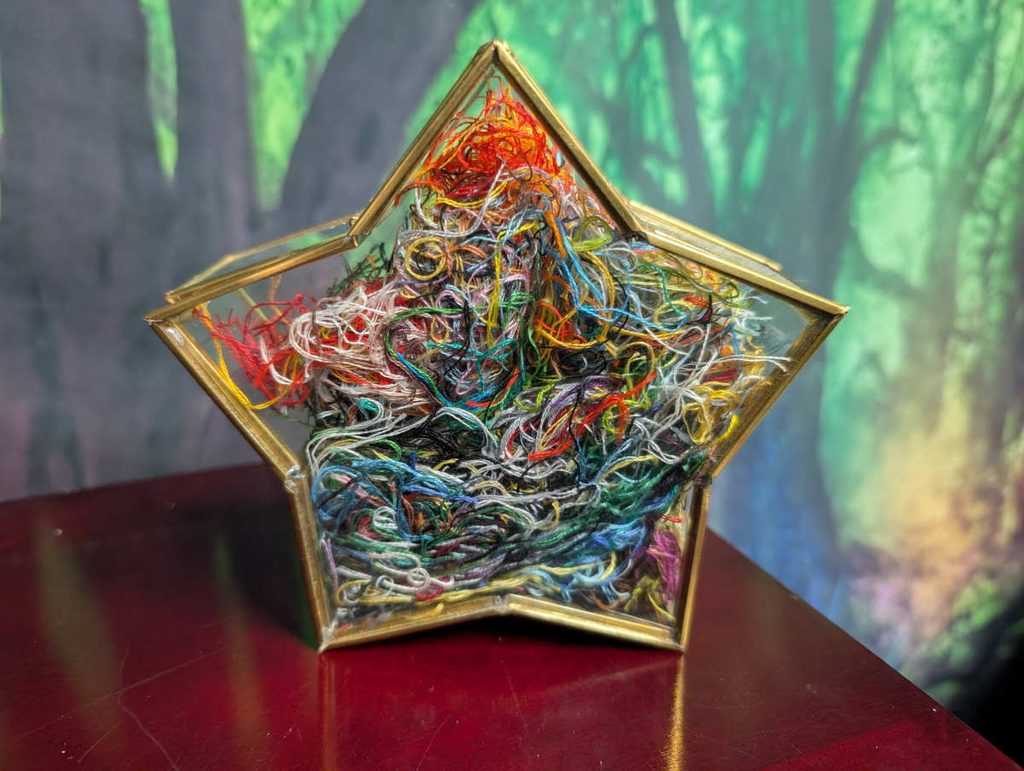 A star shaped jar full of ort threads.