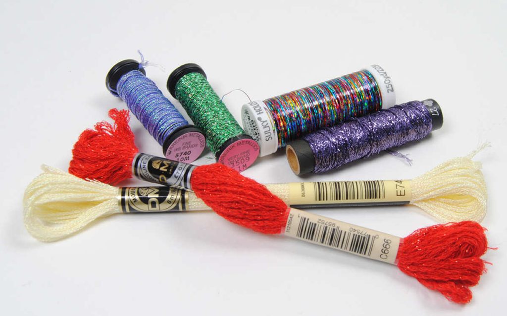 A variety of metallic embroidery threads from different brands.