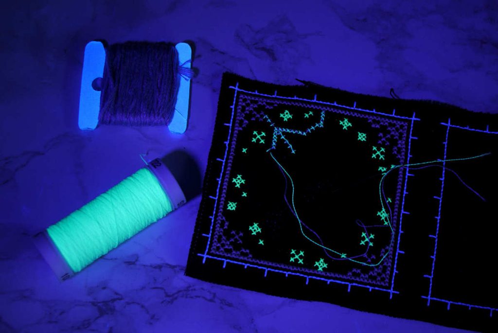 Blended Sulky Glowy and DMC cotton strands under blacklight