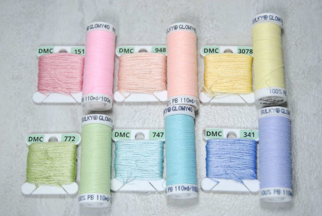 Sulky Glowy spools and their closest color DMC cotton threads for comparison