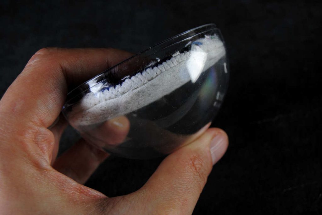 Side view of the back half of a snowglobe ornament.