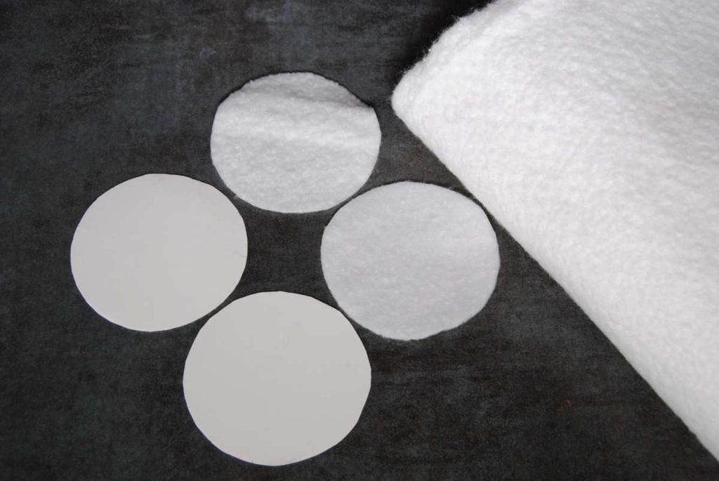 2 circles of batting and 2 circles of cardstock prepared for assembly