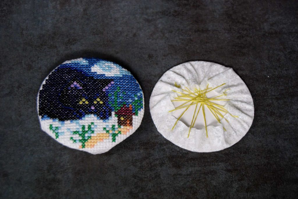 Two fabric wrapped cardstock circles ready to be stitched together.