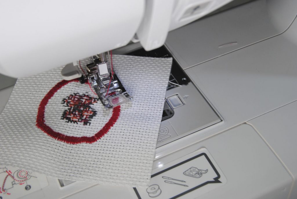 Close up of sewing a border around my iron-on patch
