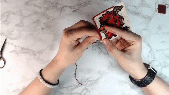Hand sewing border around a cross stitch