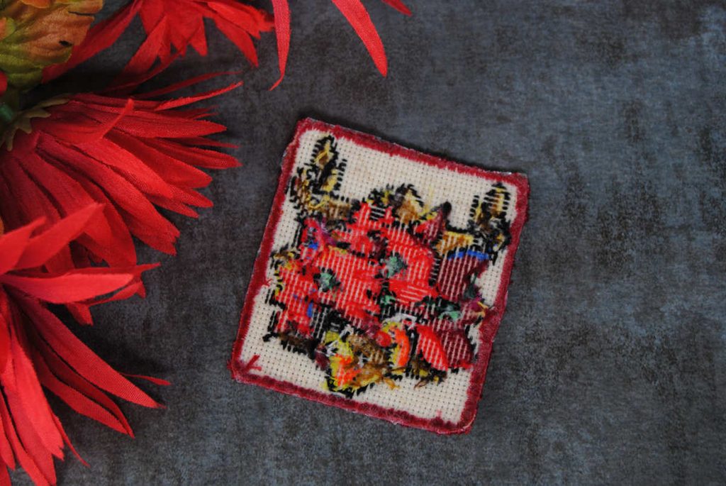 Back side of a cross stitch iron on patch of Cerberus from the game Hades.