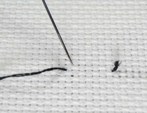 Start your away knot from the front, several stitches away from where you'll be starting stitching.
