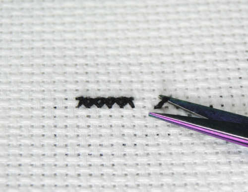 Trim the knot from the front once the tail has been anchored.