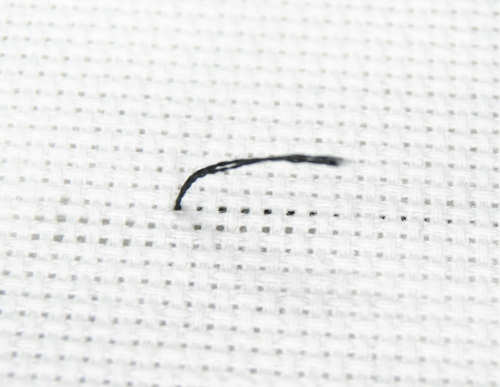 Start the first stitch by leaving a short tail on the back side of your fabric.