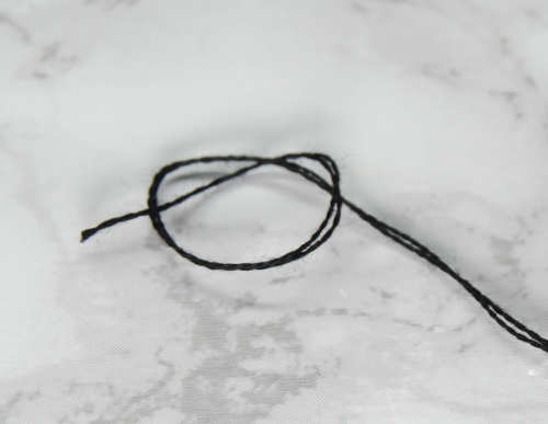 Demonstrating how to do a basic knot at the end of your embroidery thread.