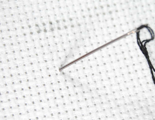 Starting a pin stitch in the very center of an aida square.