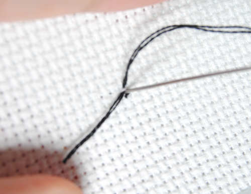 Completing the pin stitch by stitching back into the middle of your aida square.