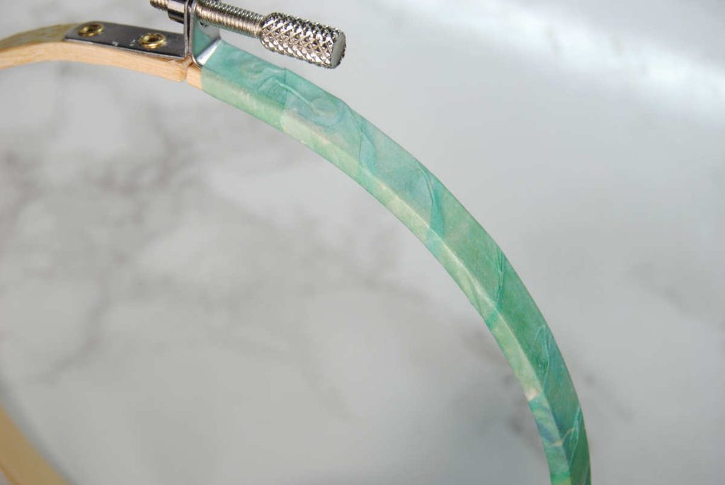 Wrapping washi tape around a wooden embroidery hoop