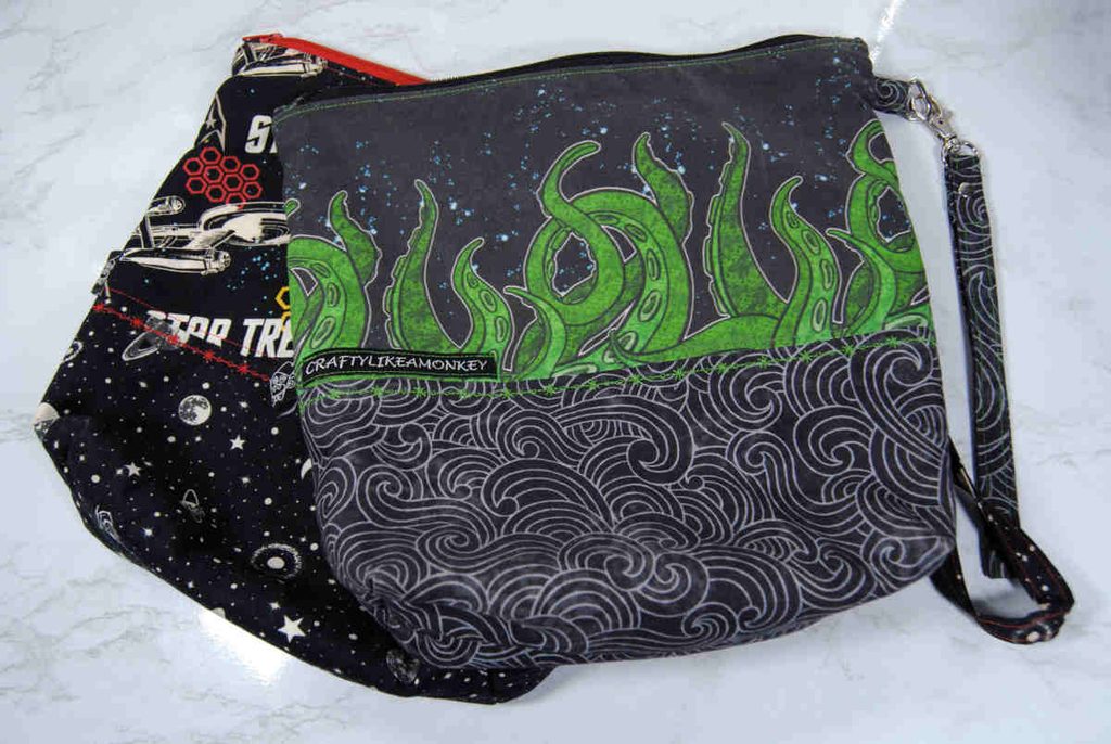Two zippered project bags by Craftylikeamonkey. One features a Star Trek print, the other has a tentacle print.