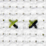 Photo of four possible combinations of quarter and three quarter cross titches.