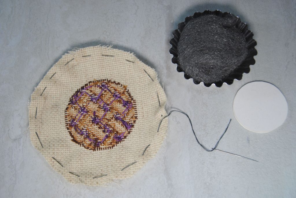 A fabric circle, with a loose running stitch border