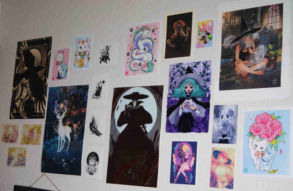 Closeup of art prints hung up in my craft room.