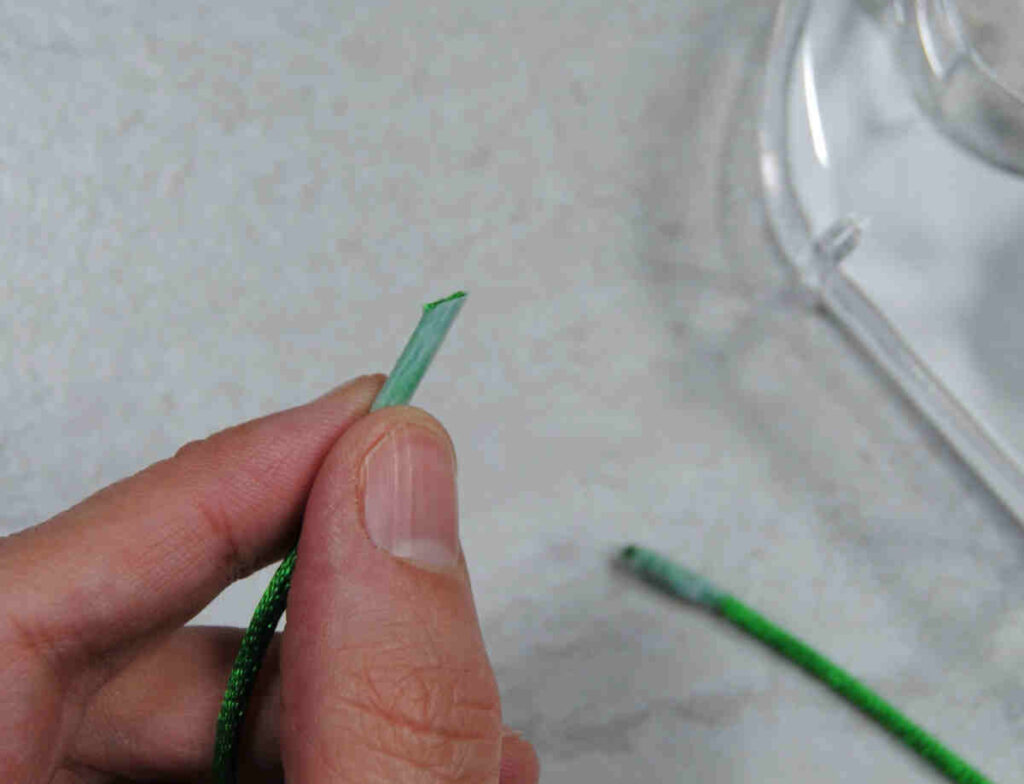 Demonstrating the angled tip of a tape wrapped cord end.