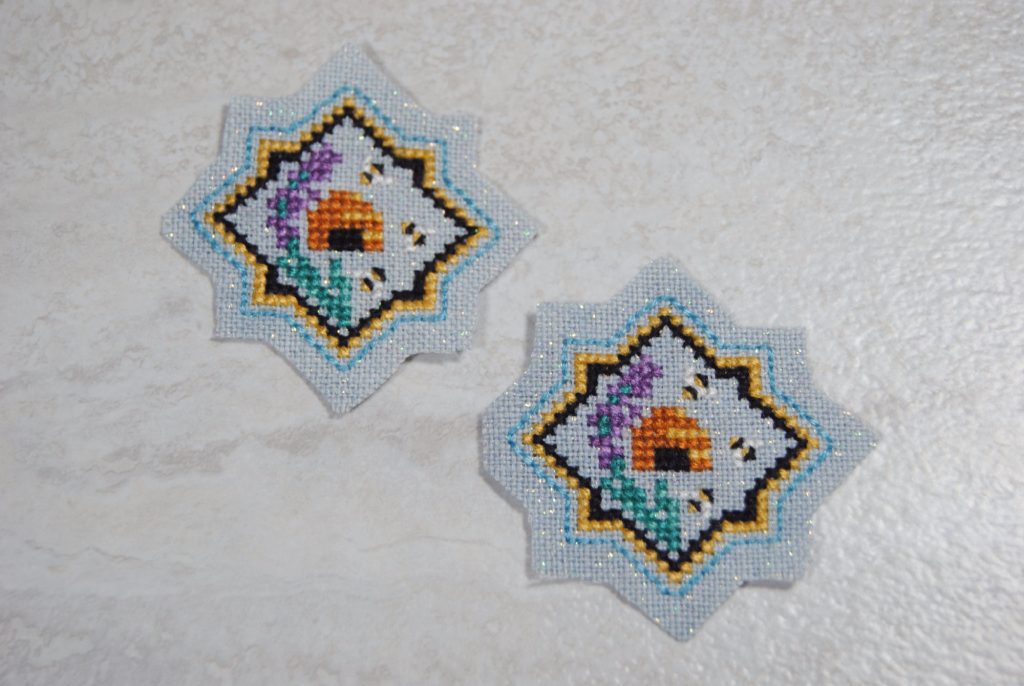 Two cross stitched mini beehive motifs cut to size.