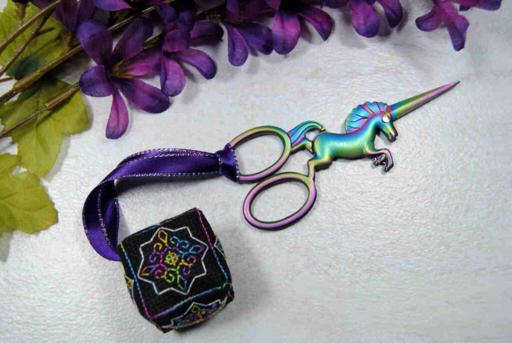 Example of a blackwork cube scissor fob designed by StormsStitches