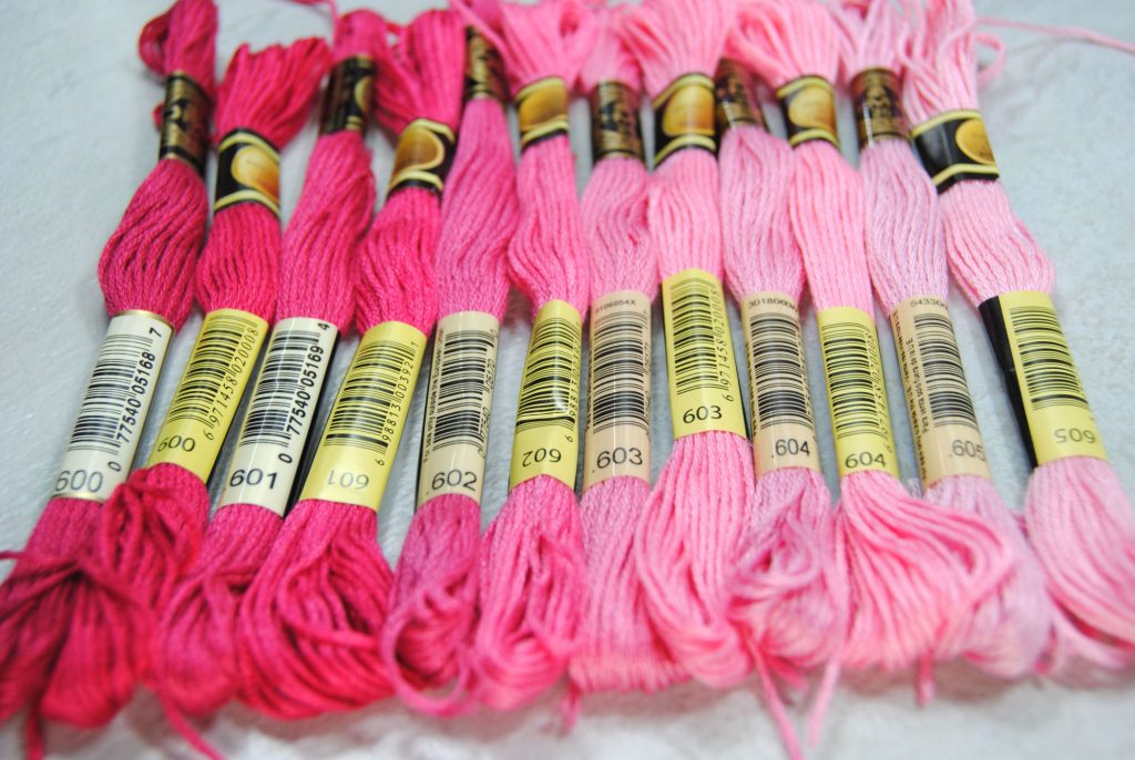 Color comparison of CXC and DMC threads, all within the pink color family.