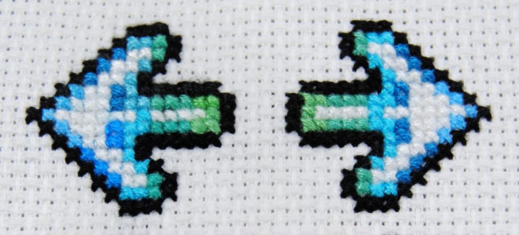 DDR arrows cross stitched to compare two brands of thread