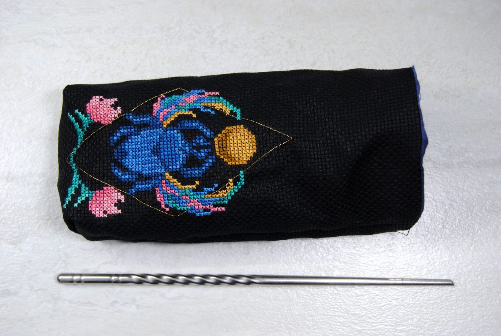 A nearly finished cross stitch tarot bag