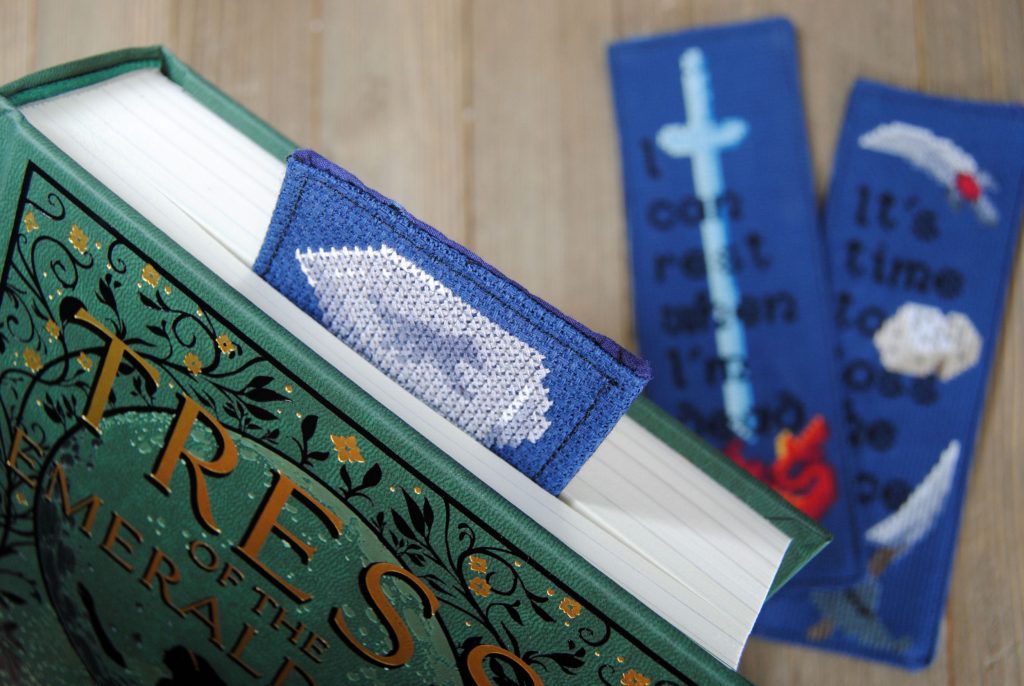 Closeup of a cross stitch bookmark in a closed book