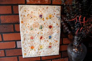 Mini cross stitch and English paper piecing floral quilt